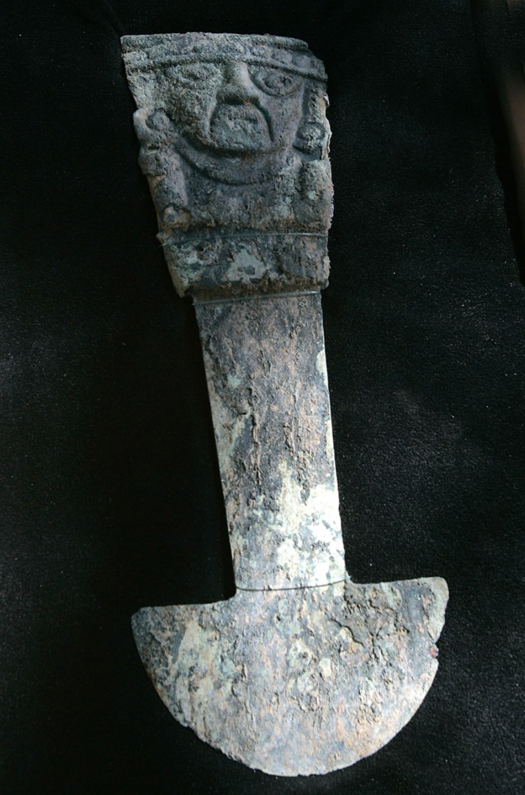 A 14-inch (34-centimeter) "tumi," a ceremonial knife made of copper alloy, is presented in Ferrenafe, Peru on Tuesday. Archaeologists in northern Peru say the artifacts found next to a pyramid in northern Peru include the first pre-Inca tumi knives ever excavated scientifically.