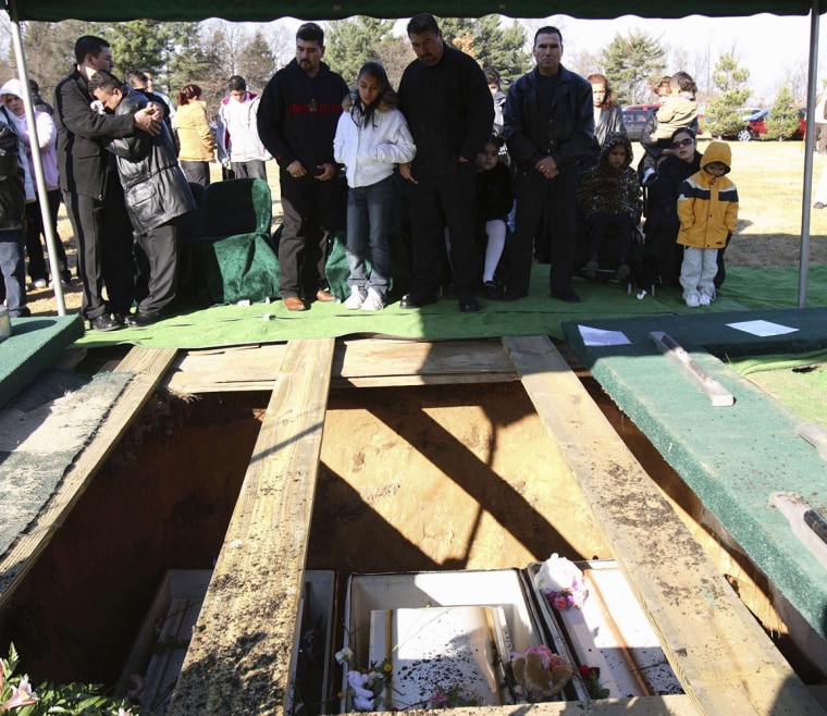 Fathers Valdez and Lopez grieve in Osceola, Indiana during funeral services for their children