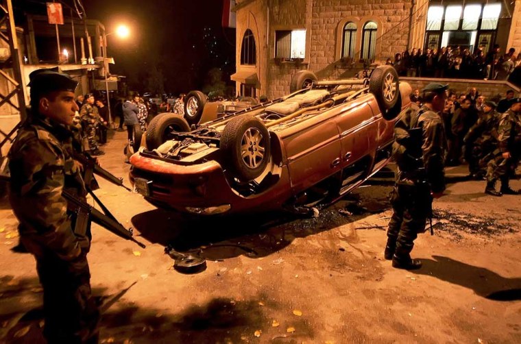 Lebanese soldiers secure an area in the Christian mountain town of Bikfaya, northeast of Beirut, after supporters of assassinated Lebanese Industry Minister Pierre Gemayel destroyed cars of supporters of the Syrian Nationalist Social Party, on Monday.