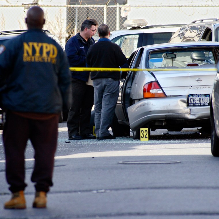 New York Police Department crime scene investigators inspect a vehicle involved in a police shooting that took place near the Kalua Cabaret, in the Jamaica section of Queens, N.Y., on Saturday.