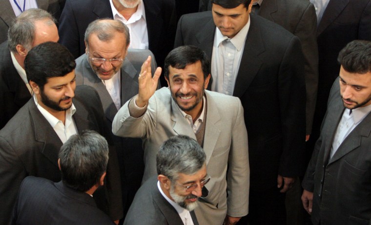 Surrounded by bodyguards and officials, Iranian President Mahmoud Ahmadinejad, center, waves after delivering a speech in Tehran, Iran, on Nov. 13.