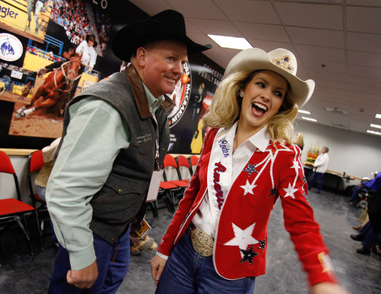 Miss Rodeo 2007 Ashley Andrews of Bowman, N.D. talks with Bronc Rumford on Saturday before the third go-round of the National Finals Rodeo at the Thomas & Mack Center in Las Vegas.