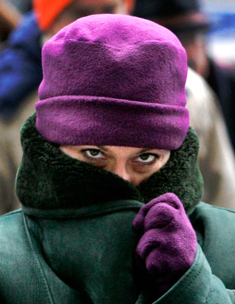 A pedestrian bundles up against wind chill below zero as she makes her way to work Monday.
