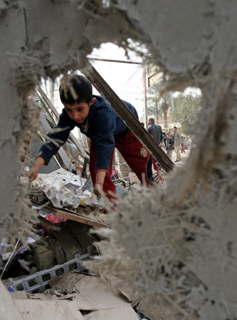 A boy on Monday inspects the ruins of a Baghdad bakery damaged in a car bombing the previous day.