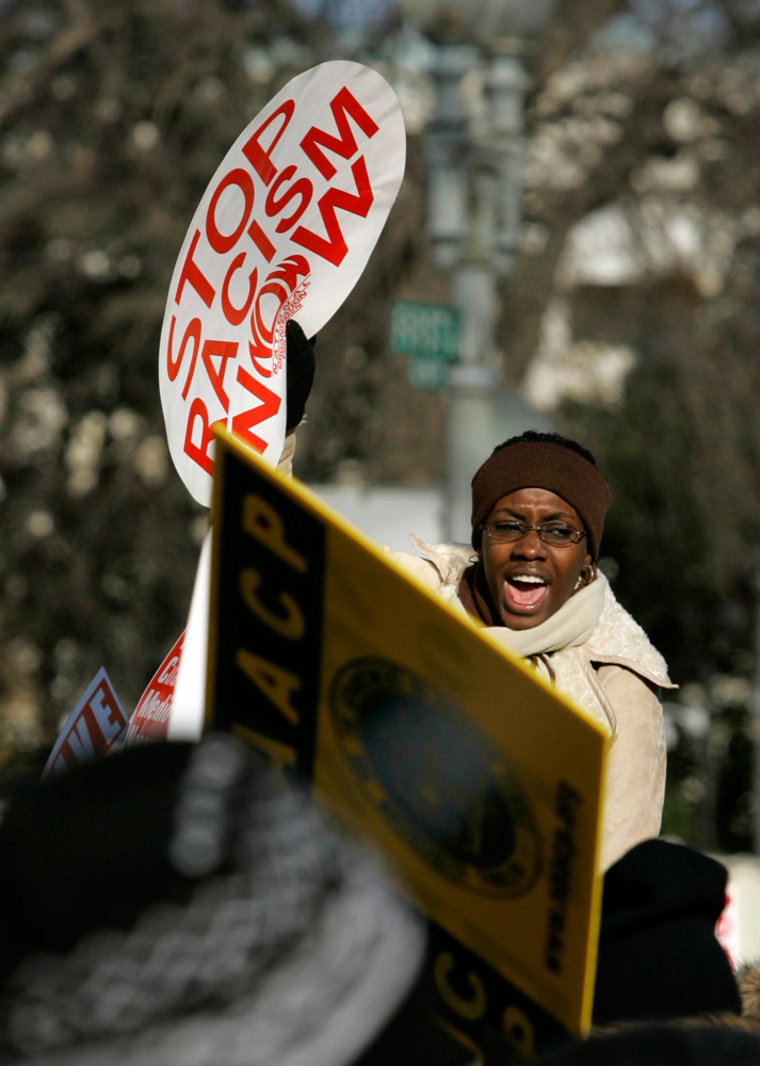 A demonstrator chants while holding a sign in front of the Supreme Court in Washington, Monday, Dec. 4, 2006 as the court heard arguments on lawsuits by parents in Louisville and Seattle who are challenging policies that use race to help determine where children go to school. . (AP Photo/Haraz N. Ghanbari)