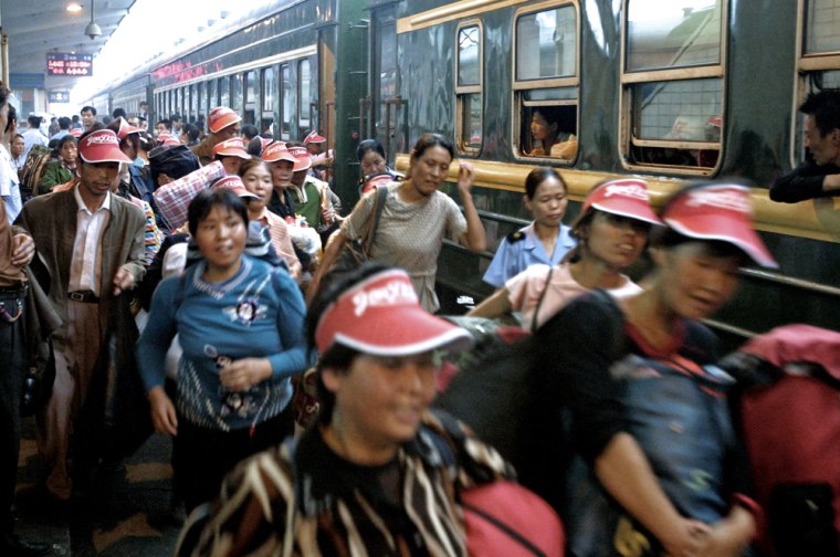 Chinese passengers rush to board a train