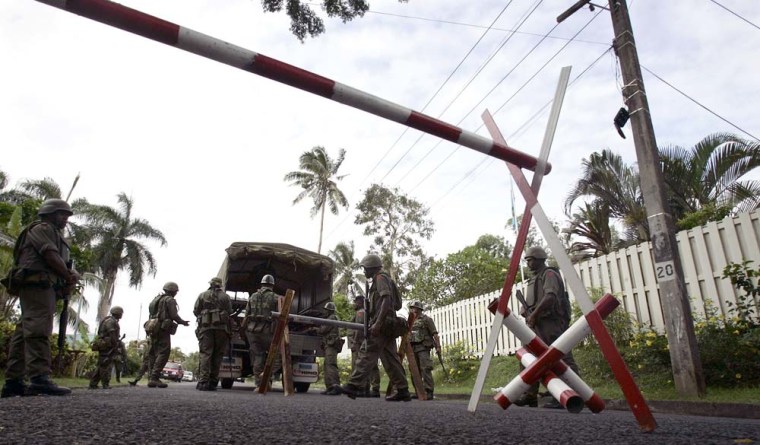 Fijian military troops blockade the entrance to Prime Minster Laisenia Qarase residence in Suva Tuesday, Dec. 5, 2006. Commander Frank Bainimarama said he had invoked special powers under the constitution to assume some powers of the president, and was using them to dismiss Prime Minister Laisenia Qarase from office and appoint an interim replacement.