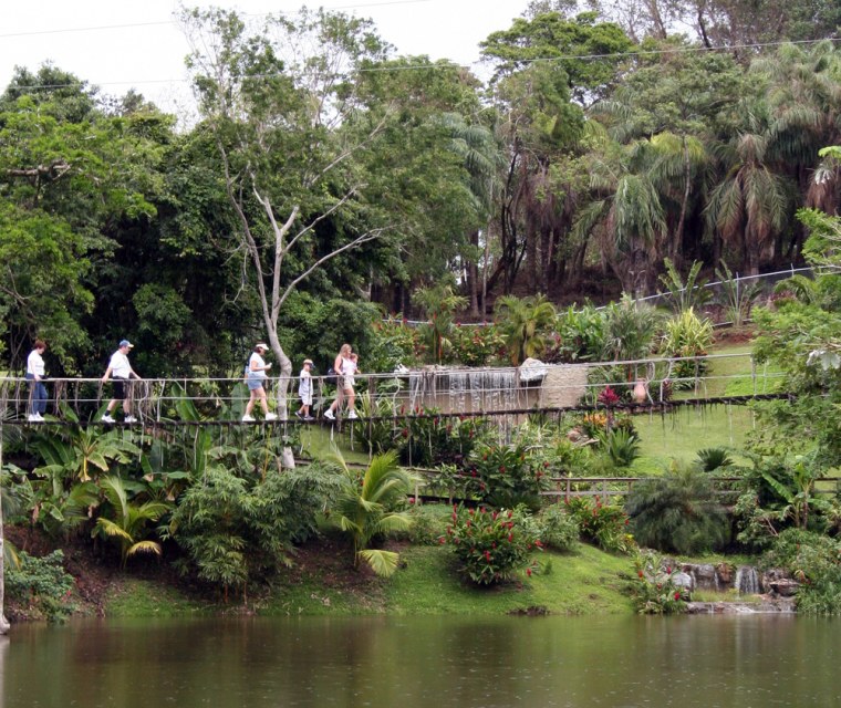 In this 2006 photo released by Gumbalimba Park, visitors walk over a manmade lake in Gumbalimba Park on the Honduran island of Roatan. (AP Photo/Gumbalimba Park)