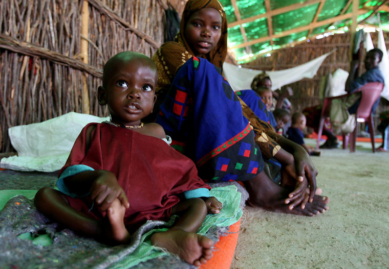 A malnourished Somali boy sits with his mother at a therapeutic feeding center in Wajid, Somalia, on Thursday. Somalia's prime minister welcomed a U.N. move opening the way for foreign peacekeepers to come to protect his embattled government, but his Islamic rivals and their Eritrean backers were bitterly opposed Thursday.
