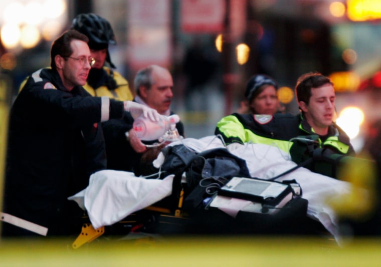 An unidentified person is loaded into an ambulance outside a commuter train station in Chicago on Friday following a shooting at a nearby skyscraper. 