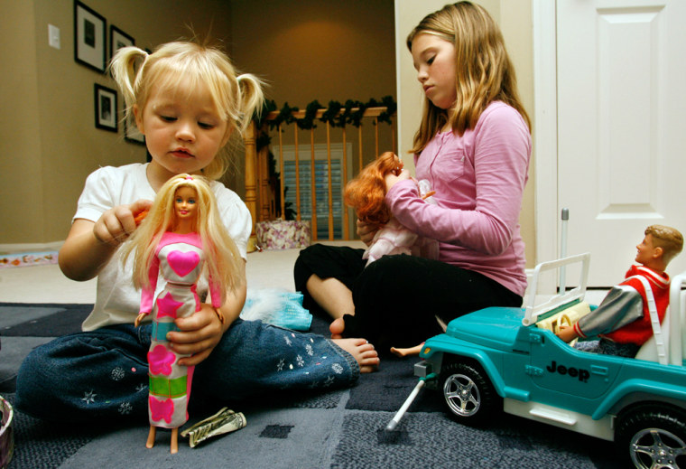 Aidia Bryant, 3, left, and her sister Cassidy Moock, 10, play with their Barbie dolls earlier this month in Lorton, Va. Barbie has managed to thrive in a time when classic toy makers have found themselves scrambling to attract new audiences. 
