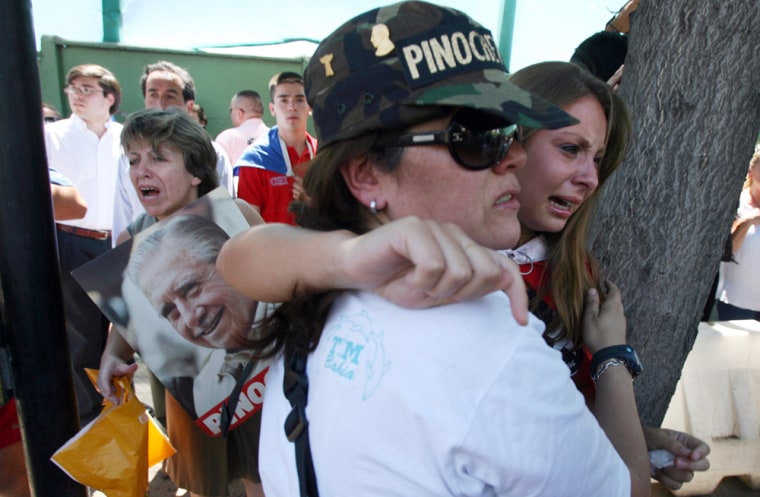 Supporters of former Chilean dictator Augusto Pinochet cry outside of Chile's Military Hospital in Santiago