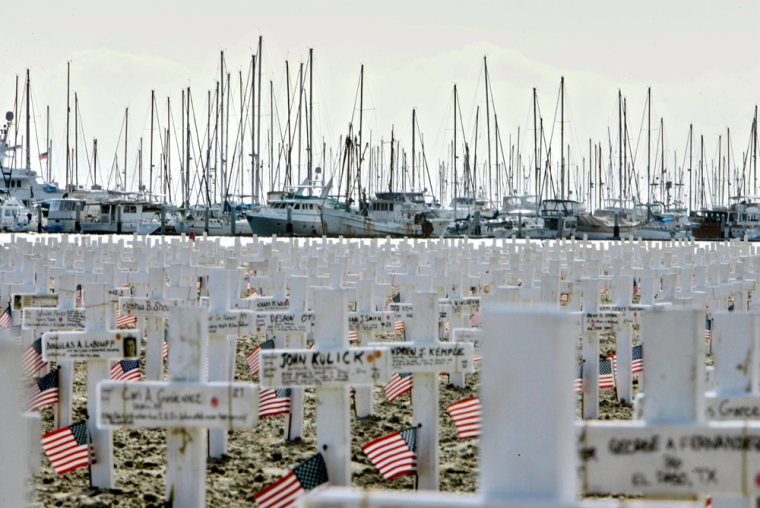 In this Dec. 10 photo, boats in the harbor form a backdrop to the thousands of wooden crosses dotting the the beach in Santa Barbara, Calif., where a makeshift memorial was set up to honor the fallen of the Iraq war.