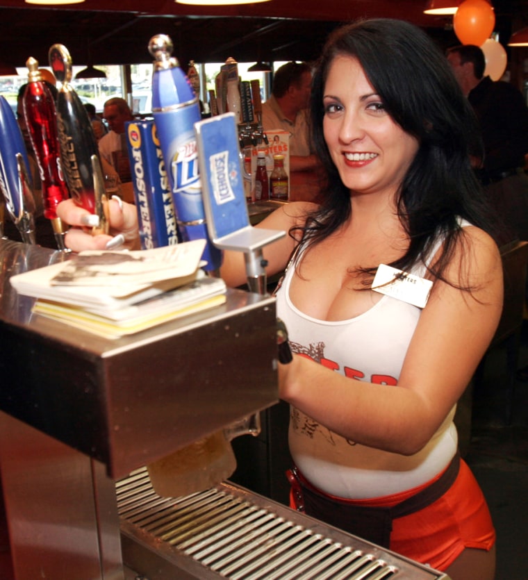 One thing Hooters won't change are the female waitstaff's uniforms — modeled here by Atlanta bartender Alexandra Carpanzano. The shorts-and-tank top have contributed to building a loyal customer base, and derision of others.