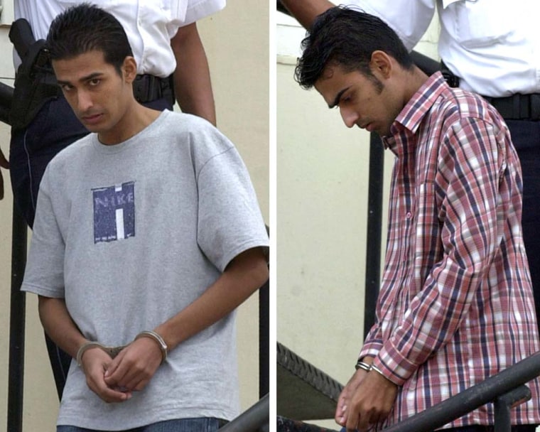 Brothers Deepak, left, and Satish Kalpoe are seen leaving court in Oranjestad, Aruba, on July 4, 2005.