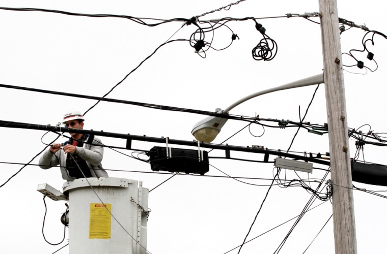 Joe DeBonis, a Verizon lineman, connects fiber optic cable that will serve a home in a North Bellmore, N.Y. Verizon expects its FiOs TV service will be available to 1 million homes by January 2007. 