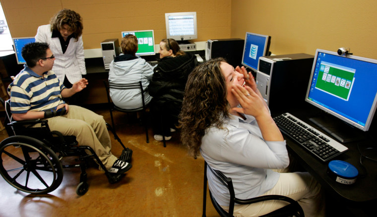 Leticia Rodriguez, right, uses a nose dot to control the cursor of a computer at Good Bytes Cafe in San Antonio. Goodwill Industries opened the Internet cafe for disabled users Dec. 15, featuring computers with a joystick mouse, magnifying software and technology allowing people to point and click with eye movements. 