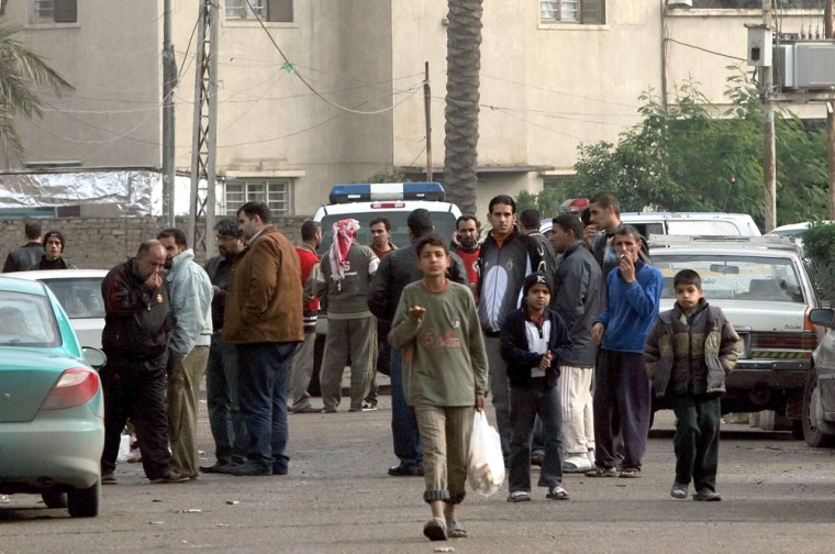 Iraqis gather around the Red Crescent headquarters in Baghdad, Iraq, on Sunday after an abduction there.