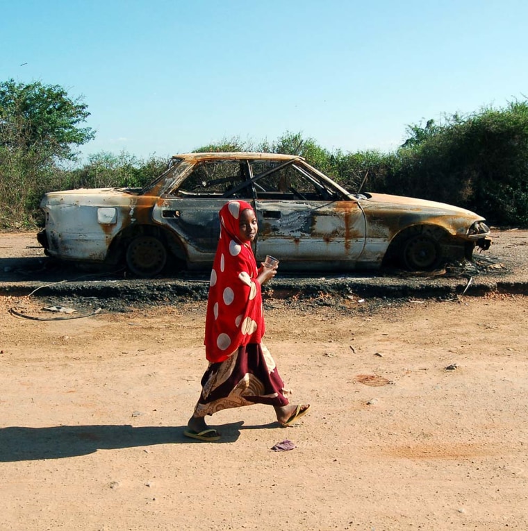A young girl walks past the remains of last month's suicide car bomb in Baidoa, Somalia, on Dec. 14.