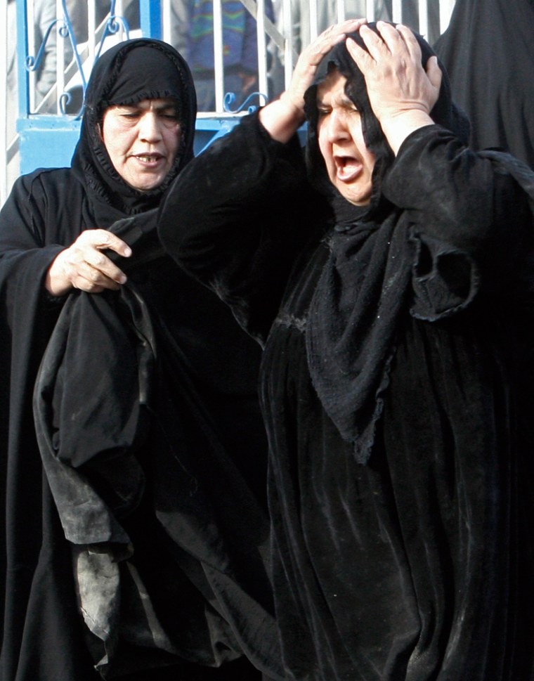 Woman cries as she waits to claim body of her son outside Kindi hospital in Baghdad