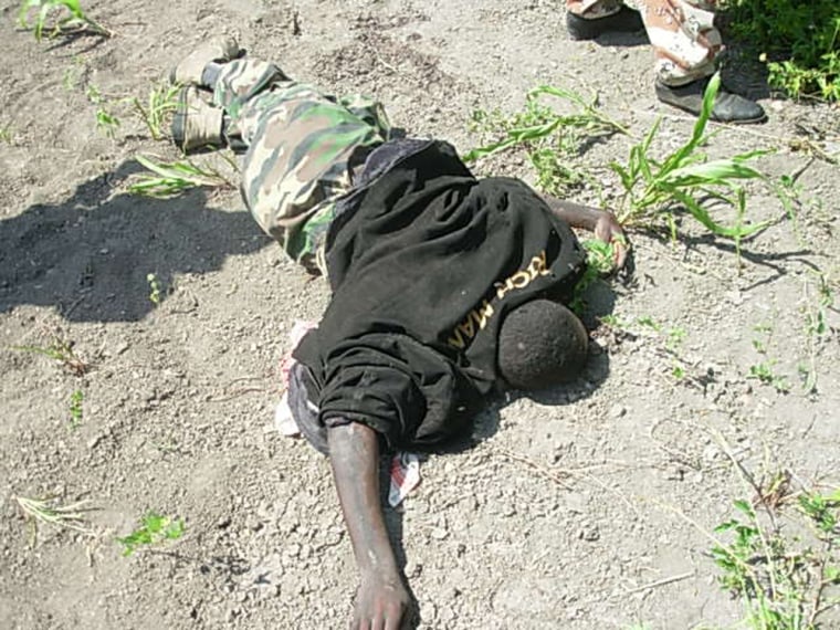 An Islamic Courts soldier lies dead on Thursday at the Moode Moode front, east of Baidoa, Somalia. Fighters pounded each other with heavy artillery and mortars for a third day Thursday as Somalia's Islamic leader announced the country was now at war, leaving a day-old peace initiative in tatters. 