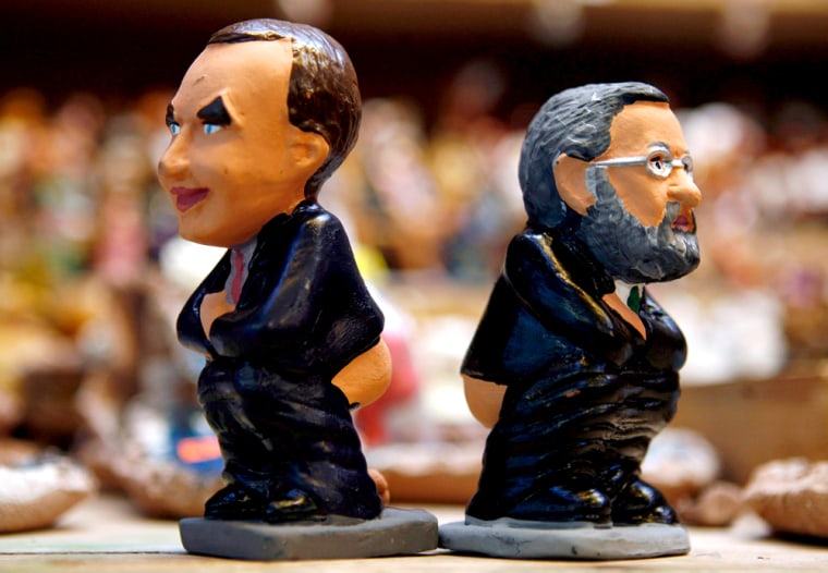 Mud figures of Spain's Prime Minister Zapatero and Spanish opposition Popular Party leader Rajoy, known as \"caganer\" are sold at Santa Llucia Christmas market in central Barcelona
