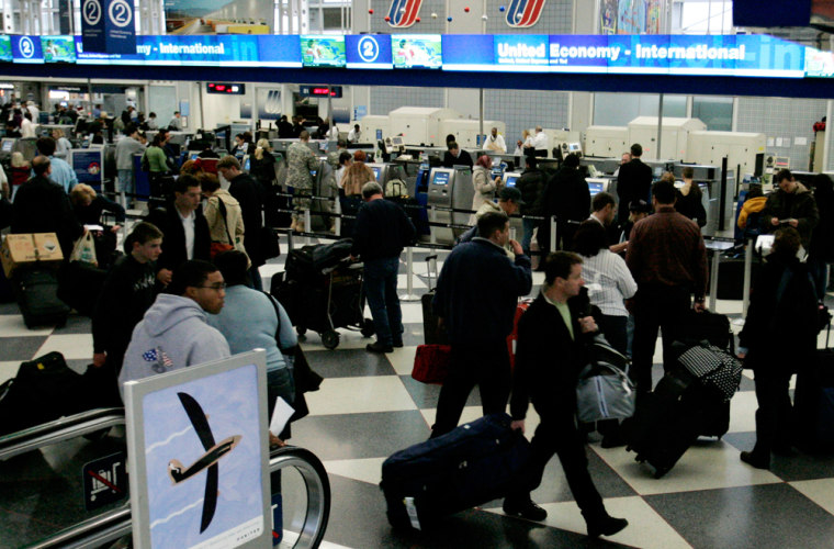 Passengers work around inside Terminal 1  at the O'Hare Airport, Thursday, Dec. 21, 2006, in Chicago. In Chicago, fog prompted the Federal Aviation Administration to reduce the number of flights coming in for all airlines at O'Hare. United spokesman Jeff Kovick said he anticipated delays of more than an hour for United flights at O'Hare. Denver's problems added to the misery at O'Hare and by Thursday afternoon, more than 100 flights had been canceled.  (AP Photo/Nam Y. Huh)