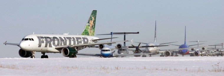 Jets are stacked up on the taxiway at Denver International Airport on Saturday.