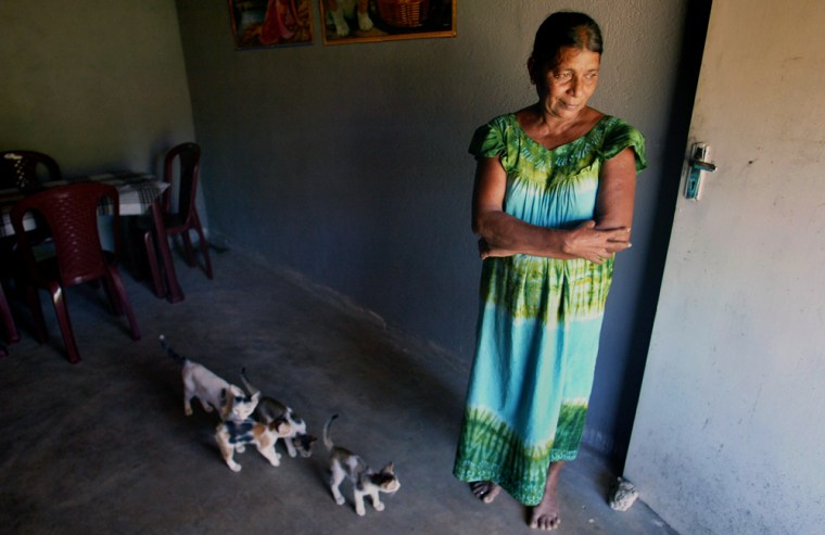 Tsunami survivor Premawathi Appuhami stands in her new house at a still-unnamed village close to her old seaside village of Peraliya, Sri Lanka, on Nov. 7.