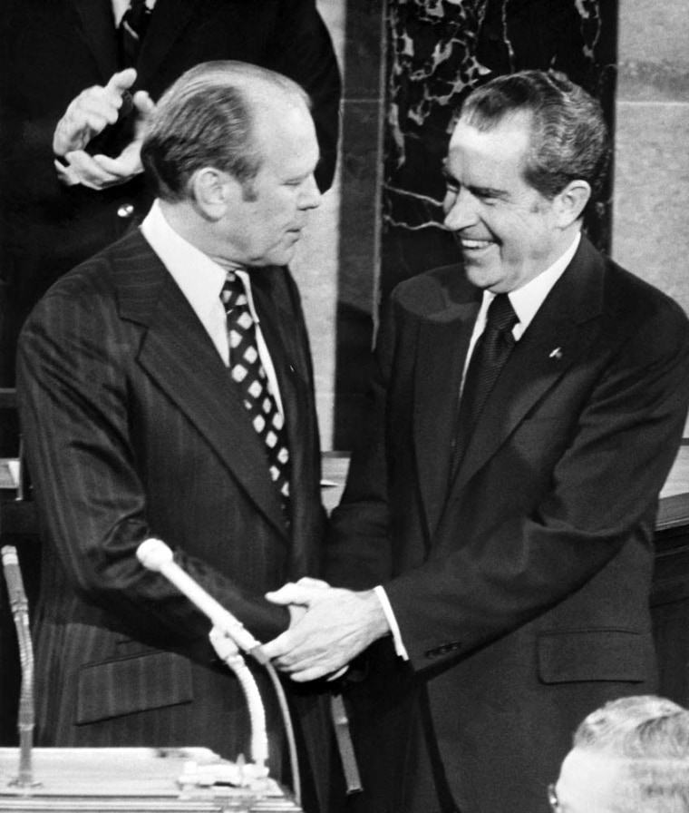 Former Vice President Gerald Ford, left, shakes hands with former President Richard Nixon in Washington, D.C., in December 1973. Ford, who said he sought to heal America after the trauma of the Watergate scandal that forced Richard Nixon from office in 1974, died December 26. He was 93.