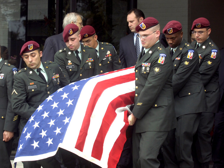 Members of the U.S. Army Garrison HHC from Fort Polk, La., carry the casket of Army Staff Sgt. Jacob Gerald McMillan after a funeral service Friday at Lafayette Memorial Park Cemetery in Lafayette, La. McMillan died in Iraq on Dec. 20 from wounds he suffered when a roadside bomb exploded near his vehicle.