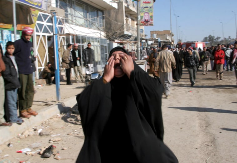An Iraqi woman cries near the explosion in Kufa, 100 miles south of Baghdad, Iraq, on Saturday.