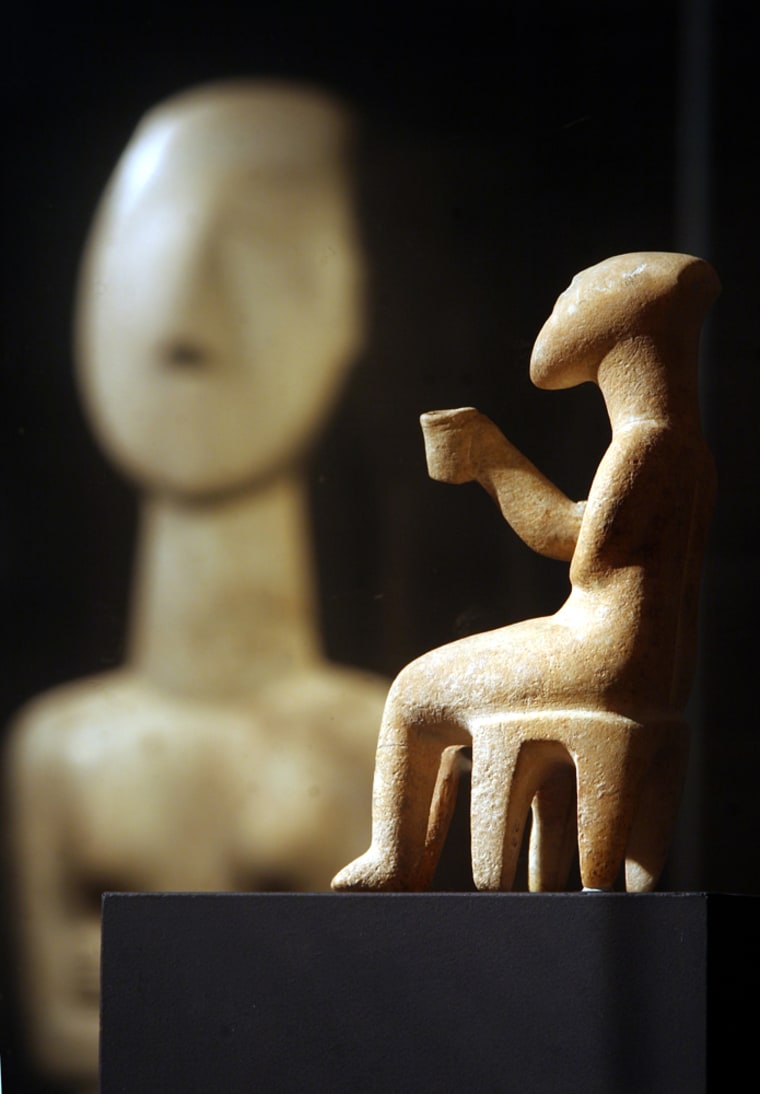 The Cup-Bearer, a Cycladic figurine of unknown provenance dating between 2800-2200 B.C., is displayed at the N. P. Goulandris Foundation-Museum of Cycladic Art in Athens. A new discovery of smashed marble figurines on an uninhabited Aegean Sea islet has shed new light on the mysterious Cycladic civilization, whose strikingly modern figurines are prized exhibits in museums and collections worldwide. 