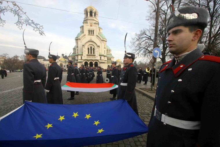 Bulgarian army honor guard hold the European Union flag during an official ceremony at the Tomb of Unknown Soldier in the Bulgarian capital Sofia, Monday, Jan. 1.