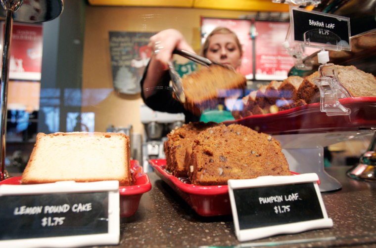 Barista Ashlyn Jacobsen picks up a slice of pumpkin loaf for a customer at a Seattle Starbucks, Tuesday, Jan. 2, 2007. Starbucks Corp. plans to eventually drop the artery-clogging trans fats from company-operated coffeehouses across the country.