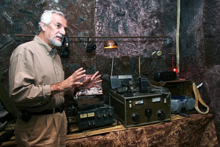 Carlos Henriquez Consalvi, founder of the clandestine Salvadoran station "Radio Venceremos," is pictured near equipment used by the radio station during the country's civil war era.