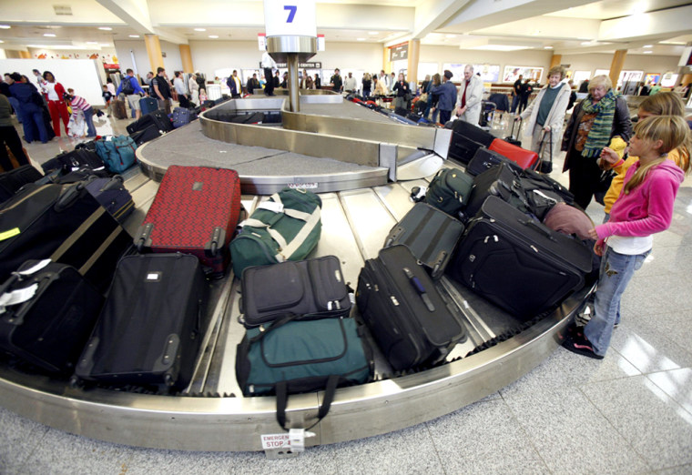 Travellers wait to claim their baggage after flying on the day before Thanksgiving in the Hartsfield-Jackson Atlanta International Airport in Atlanta, Georgia