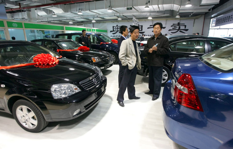 Customers look at Buick and Chevrolet cars at a sales office in Beijing, China.   