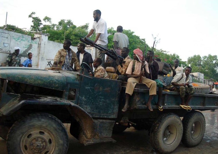 Militiamen who have defected from the Somali government ride a truck loaded with weapons through the streets of Mogadishu on Dec. 15.