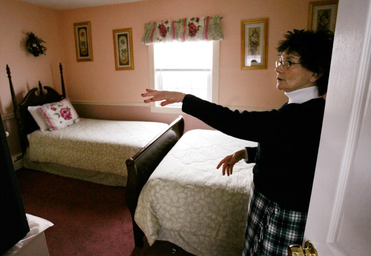 Innkeeper and former schoolteacher Mary Ellen Newbury, of Newport, R.I., displays a room at the Admiral Weaver Inn, in Newport. Newbury, a practicing Catholic who attends church each Sunday, underwent a months-long course on kosher regulations from an Orthodox rabbi to operate Rhode Island's only kosher bed and breakfast.