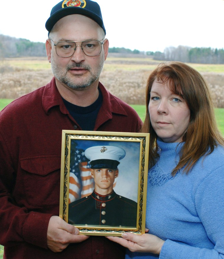 Dan and Debbie Dunham hold a portrait of their son, Marine Cpl. Jason Dunham, on the back porch of their home in Scio, N.Y., on Nov. 15, 2006. President Bush will posthumously award Dunham the Medal of Honor on Thursday.