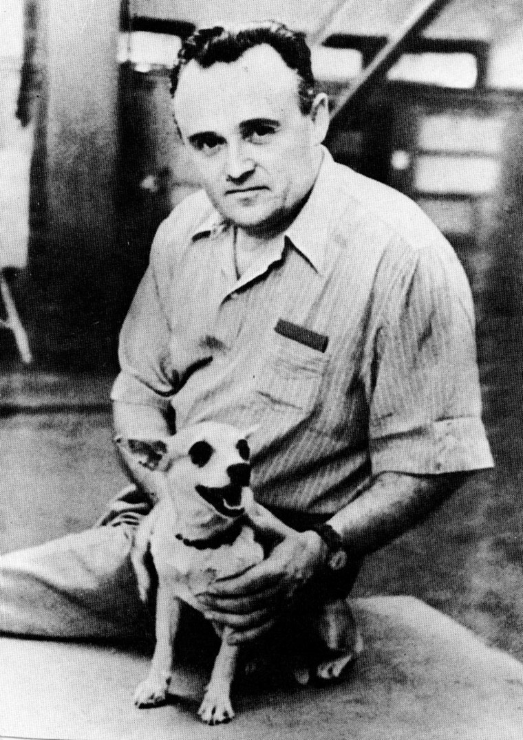 Sergei Korolyov, founder of the Soviet space program, holds a dog who was sent to an altitude of 62 miles (100 kilometers) on a suborbital scientific rocket in 1954.