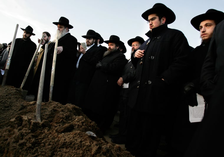 Members of the Lubavitch Jewish community prepare to bury Maryasha Garelik in New York, Thursday, Jan. 11, 2007.  Maryasha Garelik, who was approximately 106 years old when she died on Jan. 10, 2007, was witness to the whole of the 20th century and is survived by more than 550 direct descendents living on every continent except Antarctica.  (AP Photo/Seth Wenig)
