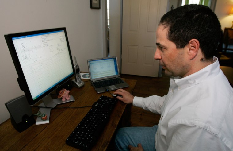 William Bianco examines astronomy data on his home computer in Bloomington, Ind. Bianco is part of a growing online community of amateur astronomers who sift through mountains of data in search of potential extraterrestrial worlds with several clicks of their mouse.