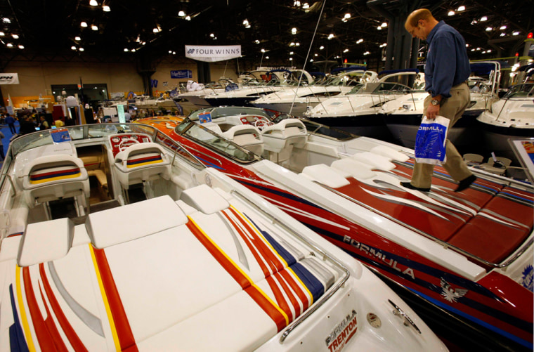 A visitor looks at speed boat at New York National Boat Show