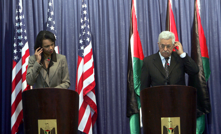 Secretary of State Condoleezza Rice, left, and Palestinian President Mahmoud Abbas adjust their translation devices during a joint news conference in the West Bank city of Ramallah on Sunday.