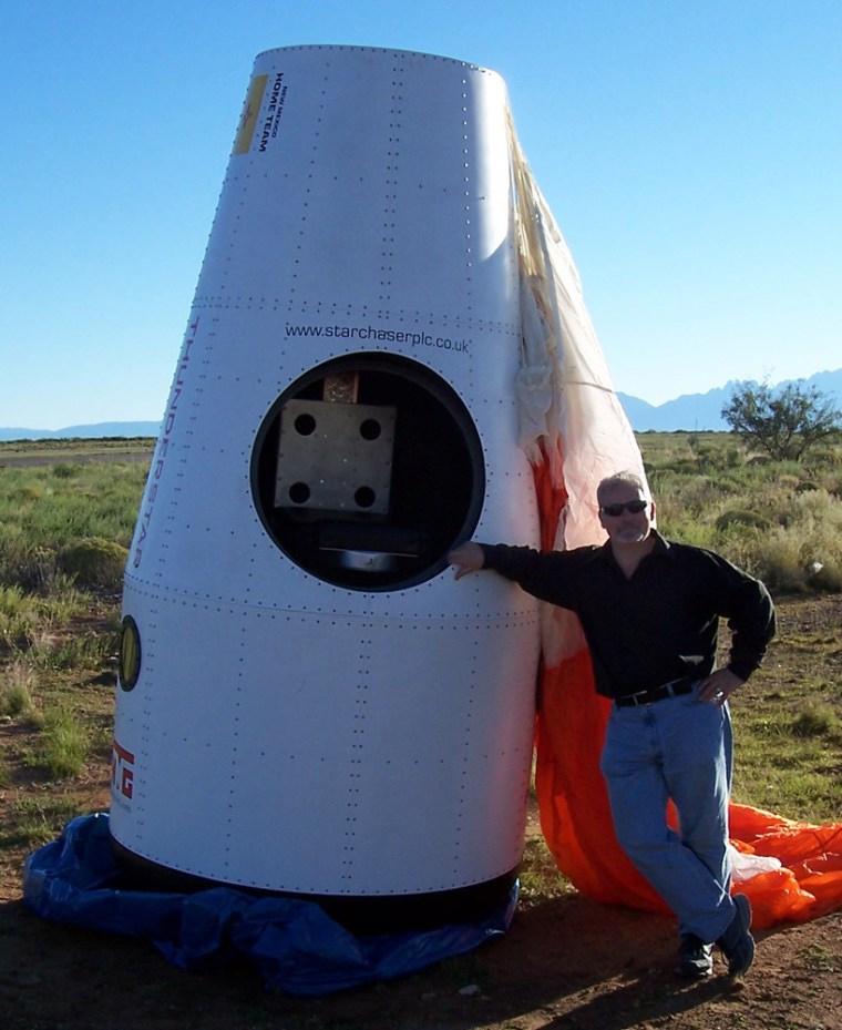 Starchaser's chief executive, Steve Bennett, leans against a prototype of his company's space capsule near Las Cruces, N.M. 