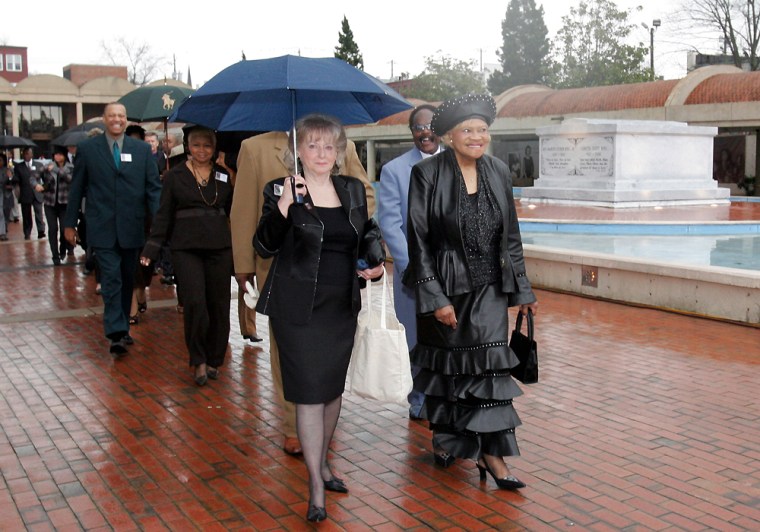 Laura Brown, 73,  right, leads a group past the tombs of the Rev. Martin Luther King, Jr. and his wife Coretta Scott King Monday, Jan. 15, 2007, in Atlanta as they walk to the Ebenezer Baptist Church for King Day commemorative services. (AP Photo/Gene Blythe)