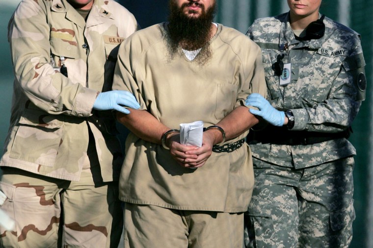 A shackled detainee is transported on the grounds of the Camp Delta detention center at Guantanamo Bay U.S. Naval Base, Cuba, in this December 2006 photo. Five years since the first detainees arrived on Jan. 11, 2002, many prisoners are still lingering in limbo, with no insight into their future.