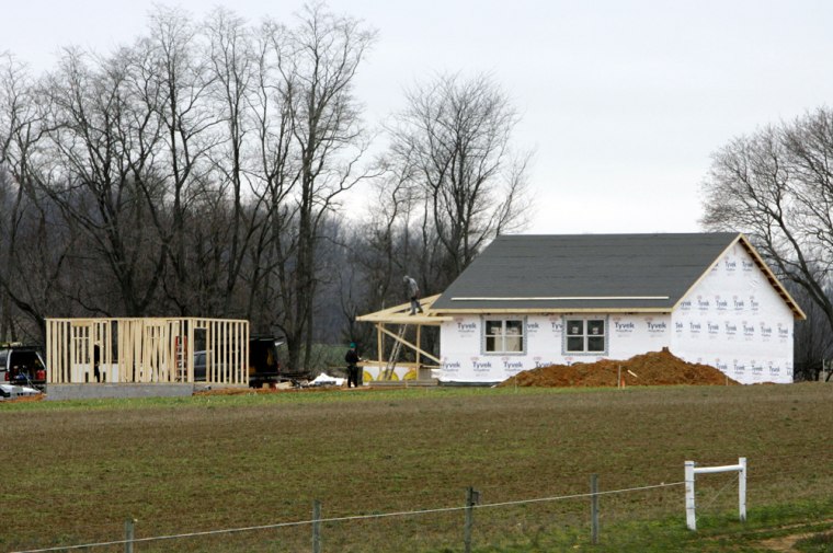 Men are seen working Thursday on structures in Nickel Mines, Pa. A new Amish schoolhouse is rising a few hundred yards from the former site of the school where a gunman shot 10 girls in October, killing five of them. 